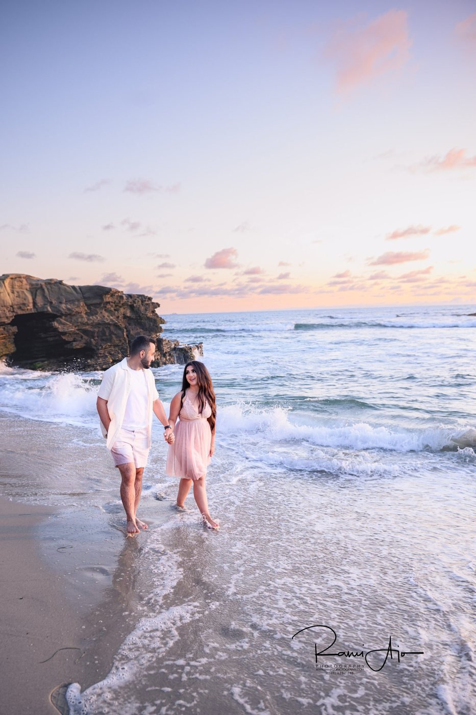 Couple walking the shoreline at La Jolla