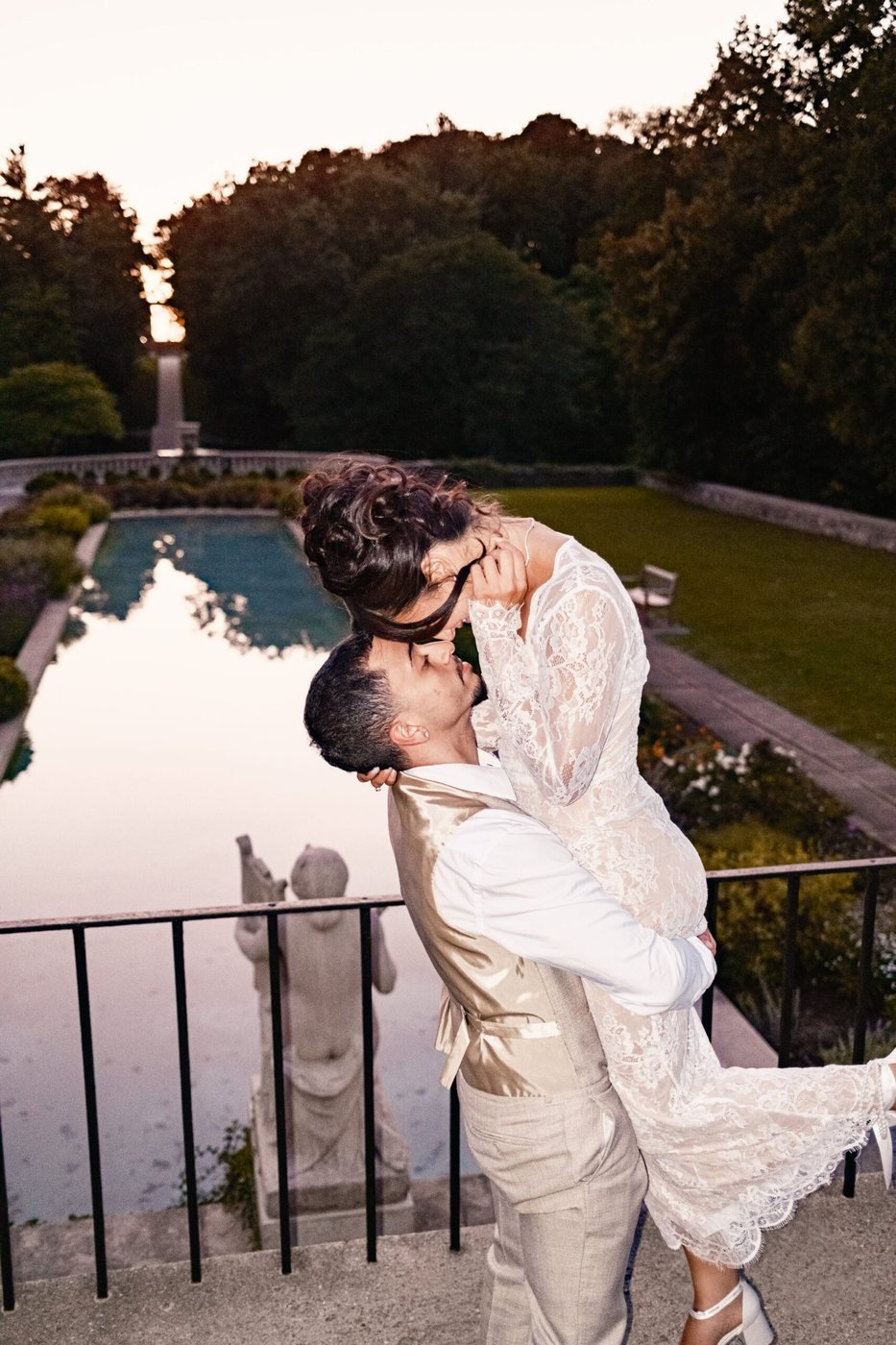 Couple in a dip kiss on a balcony at sunset
